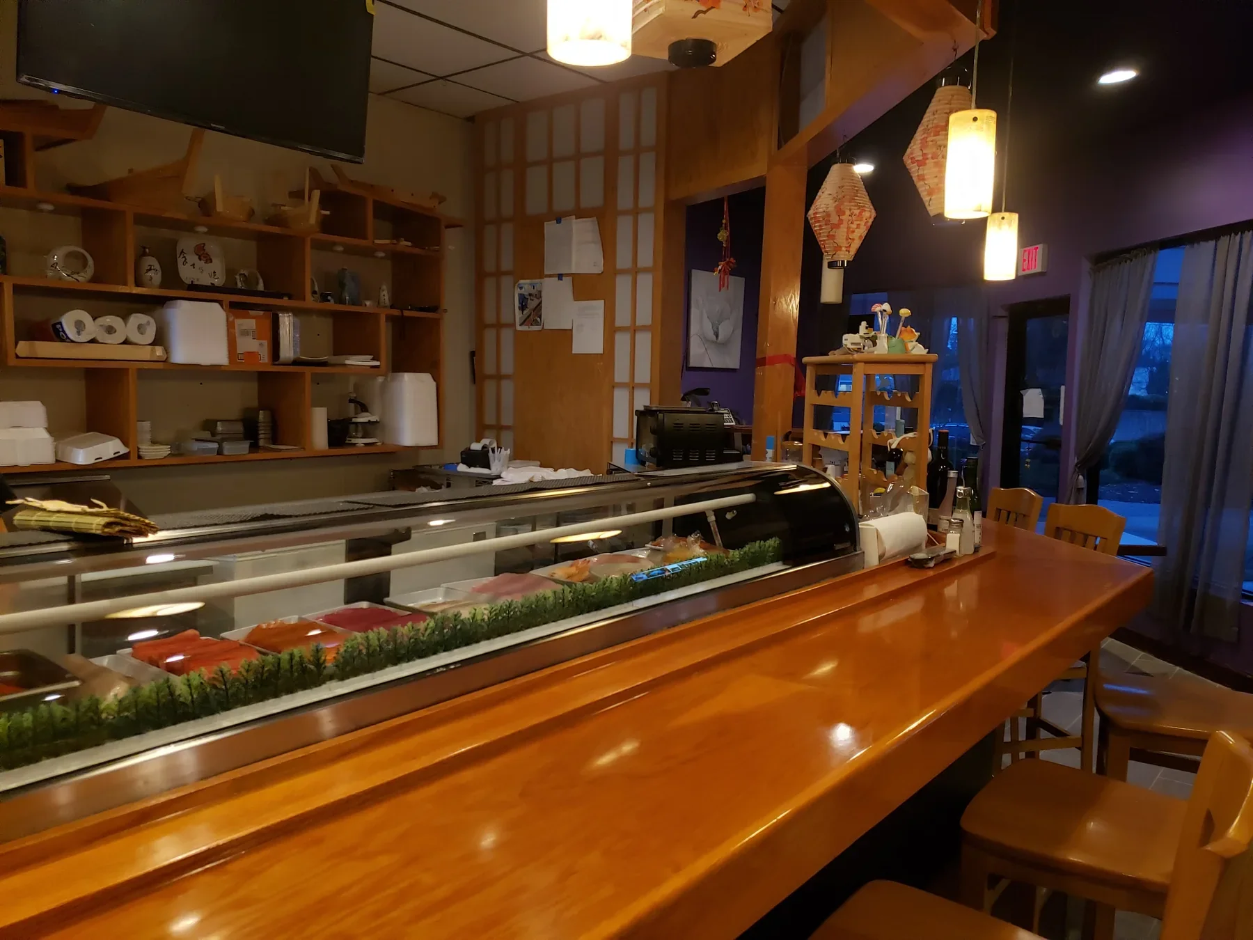 Akashi sushi bar with warm wood counter seating