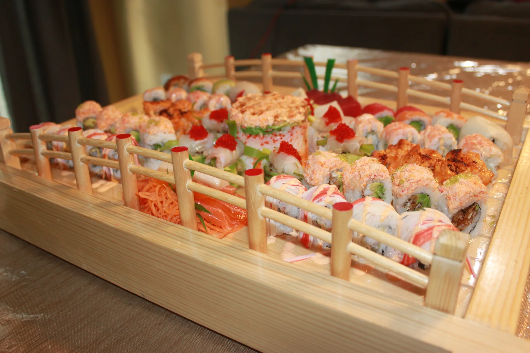 Specialty rolls and nigiri served in an Akashi sushi boat